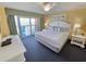 Serene bedroom with balcony access, comfortable king bed, and stylish decor at 2007 S Ocean Blvd. # 604, Myrtle Beach, SC 29577