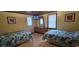 Bedroom featuring two beds with colorful floral patterns and classic wooden furniture at 202 27Th Ave. N, North Myrtle Beach, SC 29582