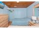 Cozy bedroom with wood paneling, comfortable bed, dresser, TV and nautical decor at 202 27Th Ave. N, North Myrtle Beach, SC 29582