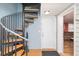 Unique spiral staircase in the entryway sets a distinct architectural tone, complemented by light-colored walls and hardwood floors at 202 27Th Ave. N, North Myrtle Beach, SC 29582