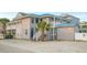 Charming two-story beach home featuring gray wood siding, a blue metal roof, and multiple elevated deck spaces at 202 27Th Ave. N, North Myrtle Beach, SC 29582