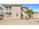 Coastal home boasting two floors with private balconies and staircase, accentuated by light gray wood and beachy landscaping at 202 27Th Ave. N, North Myrtle Beach, SC 29582