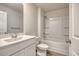Full bathroom with vanity sink and shower with white tile surround at 211 Seasons Trace Loop, Longs, SC 29568
