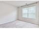 Bright bedroom featuring a window with blinds and neutral carpet at 211 Seasons Trace Loop, Longs, SC 29568
