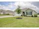 Well-manicured front yard enhances this home, complete with an attached garage and fresh landscaping at 211 Seasons Trace Loop, Longs, SC 29568