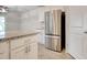 Bright kitchen features white cabinetry, granite countertops, and stainless-steel refrigerator at 211 Seasons Trace Loop, Longs, SC 29568