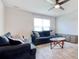 Open living room with two couches, gray wood-look flooring, and a ceiling fan at 211 Seasons Trace Loop, Longs, SC 29568