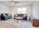 Open living room with gray wood-look flooring and a ceiling fan at 211 Seasons Trace Loop, Longs, SC 29568