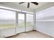 Enclosed sunroom with ceiling fan offers a bright and airy space to relax and enjoy views at 211 Seasons Trace Loop, Longs, SC 29568
