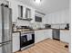 Bright kitchen features stainless steel appliances, sleek white cabinets, and modern countertops at 2196 Liberty Circle, Little River, SC 29566