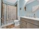 Cozy bathroom showcasing a shower with a decorative curtain, round mirror, and a neutral vanity at 2199 Birchwood Circle, Myrtle Beach, SC 29577