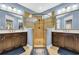 Main bathroom with walk-in shower, double sink vanity, and decorative mirrors at 2199 Birchwood Circle, Myrtle Beach, SC 29577