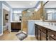 Bright bathroom featuring a glass-enclosed shower, double vanity with rich cabinetry, and coastal-inspired decor at 2199 Birchwood Circle, Myrtle Beach, SC 29577
