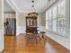 Dining area featuring wood floors, a custom light fixture, and large windows with plantation shutters at 2199 Birchwood Circle, Myrtle Beach, SC 29577