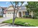 Inviting two-story home with a manicured lawn, an attached two-car garage, and a cozy front porch at 2199 Birchwood Circle, Myrtle Beach, SC 29577