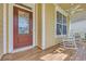 A cozy front porch with rocking chairs, beautiful details, and a relaxing space to enjoy the outdoors at 2199 Birchwood Circle, Myrtle Beach, SC 29577