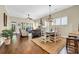 Open-concept living and dining area with hardwood floors and plantation shutters at 2199 Birchwood Circle, Myrtle Beach, SC 29577