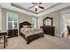 Well-lit main bedroom featuring tray ceiling, plantation shutters, and dark wood furnishings at 2199 Birchwood Circle, Myrtle Beach, SC 29577