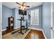 Home office featuring hardwood floors, a window with shutters, and a modern standing desk setup at 2199 Birchwood Circle, Myrtle Beach, SC 29577