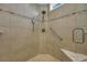 Detailed view of the tiled shower featuring a shower seat, safety bar, and overhead showerhead at 2199 Birchwood Circle, Myrtle Beach, SC 29577