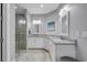 Bathroom includes a glass shower, tile floors, a dual sink vanity with granite countertop, and modern lighting at 2336 Tidewatch Way, North Myrtle Beach, SC 29582