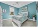 Nautical themed bedroom with a white bed frame, light blue walls, and bright colorful bedding at 2336 Tidewatch Way, North Myrtle Beach, SC 29582