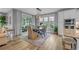 Dining area with a modern light fixture, a dining table set for six, and white draperies at 2336 Tidewatch Way, North Myrtle Beach, SC 29582