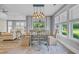 Open concept dining space features a table set for six, modern light fixture, and large windows at 2336 Tidewatch Way, North Myrtle Beach, SC 29582