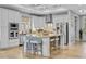 Bright, open kitchen with an island, seating, stainless steel appliances, and light wood floors at 2336 Tidewatch Way, North Myrtle Beach, SC 29582