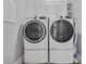 The laundry room features a new washer and dryer set with bright white cabinets above them at 2336 Tidewatch Way, North Myrtle Beach, SC 29582