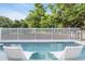 Relaxing backyard pool view with chaise lounges and white picket fence at 2336 Tidewatch Way, North Myrtle Beach, SC 29582