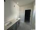 Modern bathroom features a double vanity with sleek fixtures and a doorway leading to the toilet and shower at 3012 Palma Way, Myrtle Beach, SC 29579