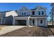 Charming two-story home with gray siding, an open garage, and an inviting front entrance at 3012 Palma Way, Myrtle Beach, SC 29579