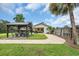 Landscaped backyard boasts a gazebo with outdoor seating, plus a garage, lawn, and privacy fence at 312 S Poplar Ave., Andrews, SC 29510
