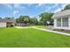 Expansive backyard features lush grass, a wooden gazebo, and mature trees, perfect for outdoor activities at 312 S Poplar Ave., Andrews, SC 29510