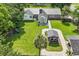 Expansive backyard featuring a playset, well-maintained lawn, patio, and outdoor kitchen area with shade at 312 S Poplar Ave., Andrews, SC 29510