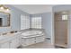 Bright bathroom features a soaking tub, double vanity, and a walk-in shower at 312 S Poplar Ave., Andrews, SC 29510