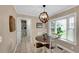 Bright dining area featuring a round table, elegant chandelier, and large window at 312 S Poplar Ave., Andrews, SC 29510