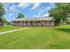 Well-kept brick ranch-style home featuring a metal roof and a spacious front yard at 312 S Poplar Ave., Andrews, SC 29510