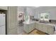 Bright kitchen with white cabinets, white countertops and view into the dining room at 312 S Poplar Ave., Andrews, SC 29510