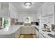 Well-lit kitchen with white cabinetry, stone backsplash, and stainless steel appliances at 312 S Poplar Ave., Andrews, SC 29510