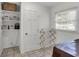 Functional laundry room with built-in shelving and natural light from the window at 312 S Poplar Ave., Andrews, SC 29510