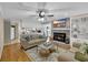 Open living space featuring a fireplace, built-in shelving, hardwood floors and ceiling fan at 312 S Poplar Ave., Andrews, SC 29510