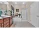 Spacious bathroom with cherry vanity, soaking tub, glass-enclosed shower, and tile flooring at 327 Trestle Way, Conway, SC 29526