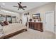 Large main bedroom with a tray ceiling, ceiling fan, dark furniture, and an adjacent sitting area at 327 Trestle Way, Conway, SC 29526