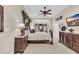 Spacious bedroom with tray ceilings, ceiling fan, large bed, dual night stands, and an adjacent sitting room at 327 Trestle Way, Conway, SC 29526