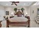 Main bedroom with tray ceilings, dark furniture, large plants, ceiling fan, and carpet flooring at 327 Trestle Way, Conway, SC 29526