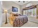 Bedroom with a large window, blinds, window treatment and a queen bed with paisley bedding at 327 Trestle Way, Conway, SC 29526