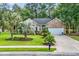 Well-maintained brick home features a lush lawn and mature landscaping, creating inviting curb appeal at 327 Trestle Way, Conway, SC 29526