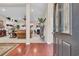 Inviting foyer with hardwood floors offers a view of the open-concept living space at 327 Trestle Way, Conway, SC 29526